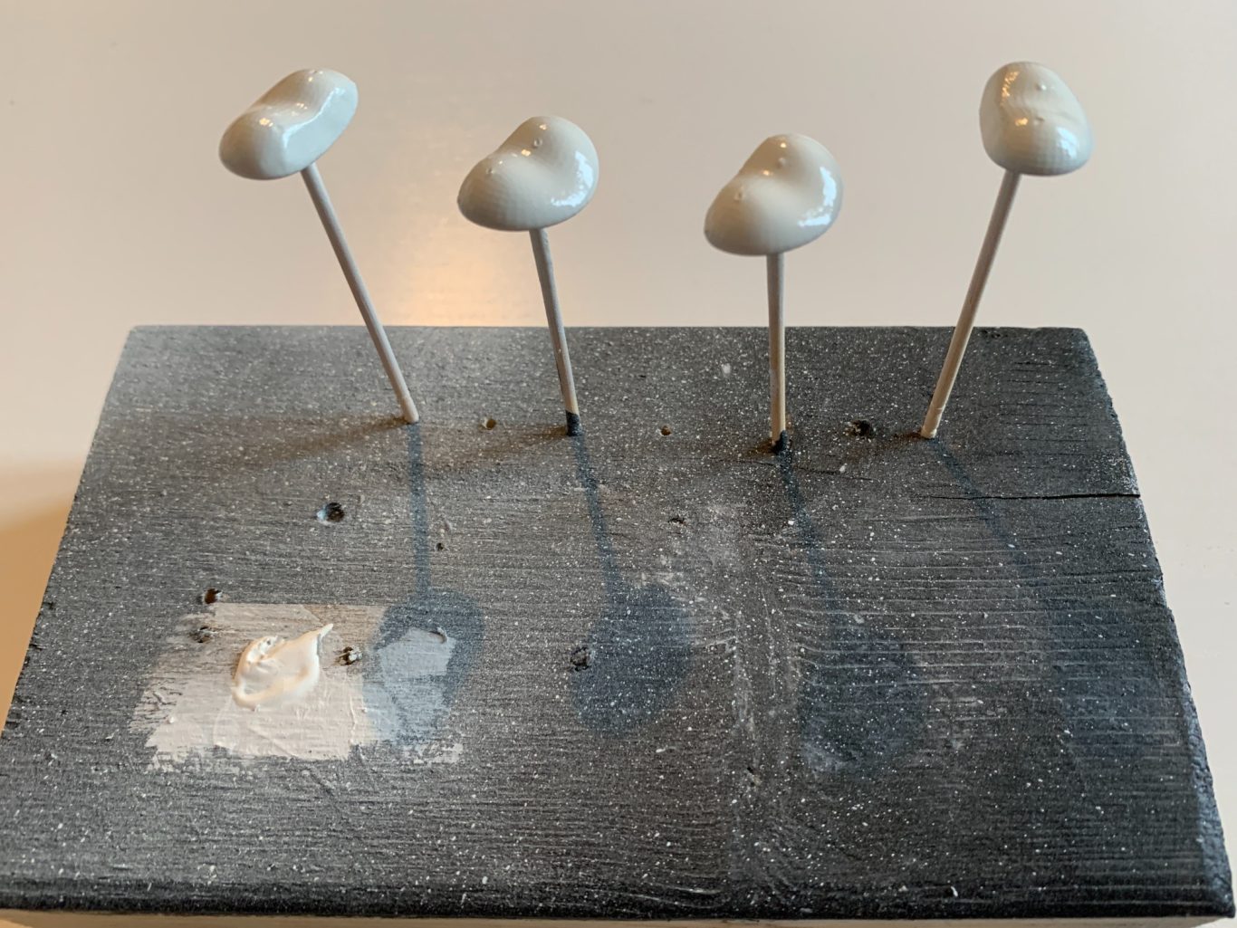 Tongues getting primed with white before being painted with red nail polish